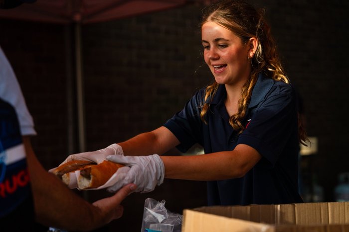 A volunteer serving at the ESLAC barbeque