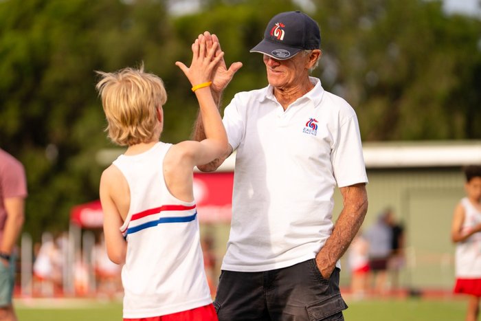 An ESLAC coach high-fiving an athlete at ES Marks