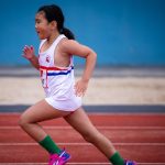 Little Athletics sprinter at full stride on the track at ES Marks